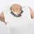 This stunning Kenzo Paris necklace features a heavy silvered metal chain adorned with Murano glass charms. The charm...