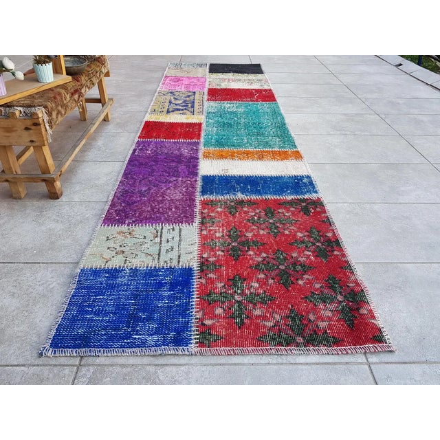 This is a vintage Turkish Oushak rug from the Mid 20th Century. The piece was hand-knotted.