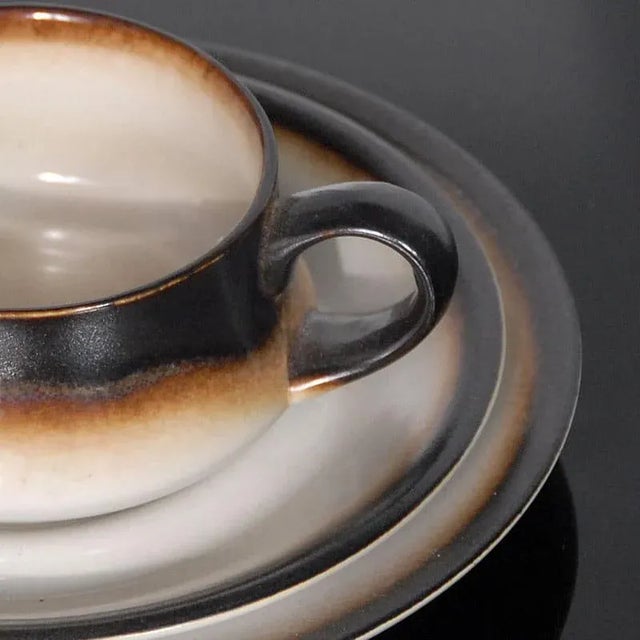 This porcelain coffee set for four people was made in Italy and consists of four cups with saucers. This piece is...