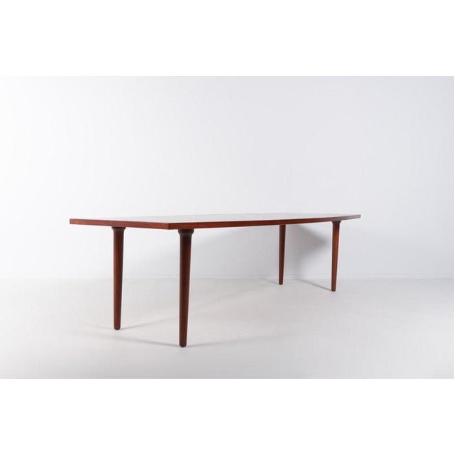 Large Danish Modern varnished teak table from Johannes Andersen. Spectacular form and craftsmanship. Condition Good, few...