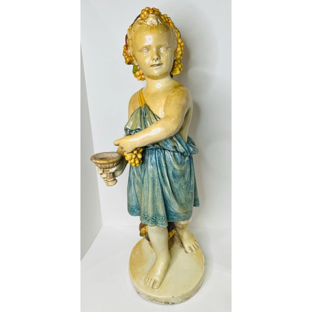 Majestic italian della robia statue holding a horn a plenty with grapes in the other hand and a basket of grapes near her...