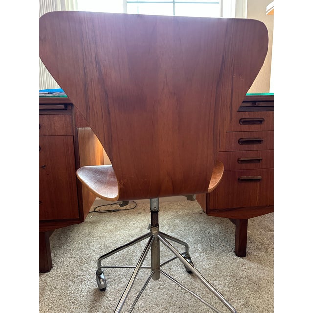 Authentic Arne Jacobsen Danish teak adjustable-height swivel desk chair, a true mid-century modern collectible. Features...