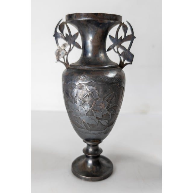 We are selling this pair of early 20th Century Chinese silver vases. These vases are simply made with floral ears and...