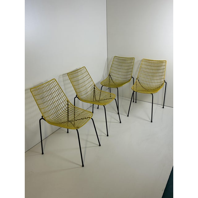 stackable and collapsible chairs in yellow and black lacquered iron
