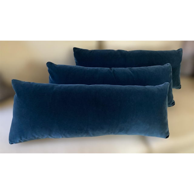 Soft navy velvet covers this set of three rectangular lumbar pillows, each finished with a knife edge, invisible zipper,...