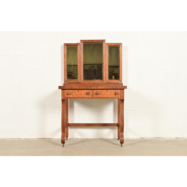 A gorgeous antique American Empire tiger oak vanity dressing table with mirror In the manner of R.J. Horner & Co. USA,...