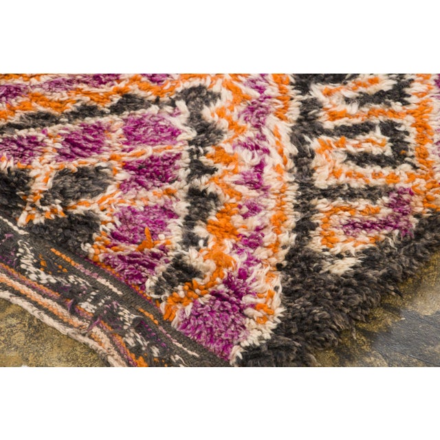 Hand-knotted in wool and originating circa 1950-1959, this 6x11 vintage Moroccan berber rug joins Rug & Kilim’s Moroccan...