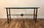 Solidly built metal table with turned legs and embellishments, topped with a thick, beveled, green tinged glass. Made to...