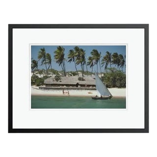 Slim Aarons 'The Lure of Lamu' Archival Pigment Print Framed in Black For Sale
