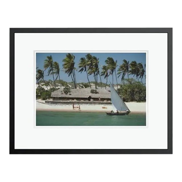 Slim Aarons 'The Lure of Lamu' Archival Pigment Print Framed in Black For Sale