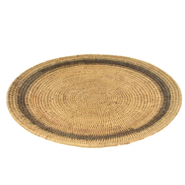 Handwoven Makenge flat wedding basket handmade by the Mbundu women within Zambia. These baskets are traditionally made...