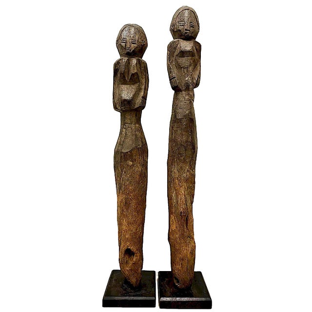 On offer is a pair of vintage hand-carved African figures. These serve as a classic example of traditional African post...