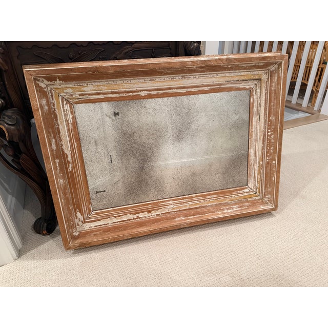 Large rustic wall mirror featuring a beautifully distressed wood frame with layered natural patina. The frame showcases...