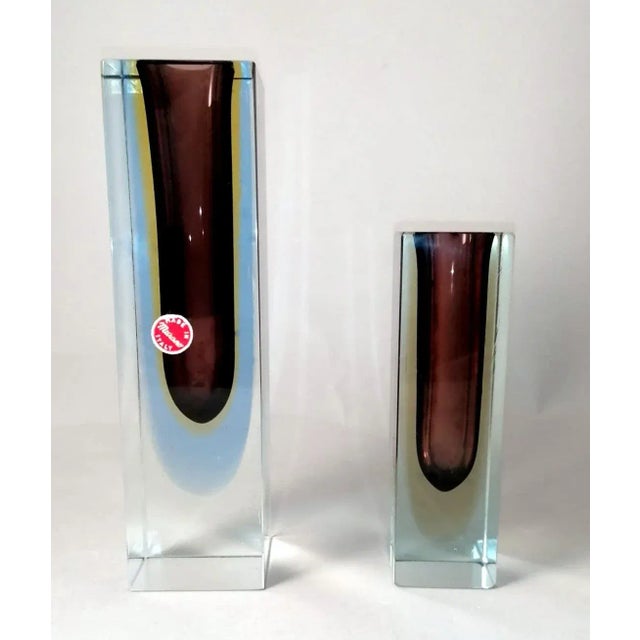The pair consists of two massive and linear Murano glass vases of three colors; they have a strong line, with sharp,...