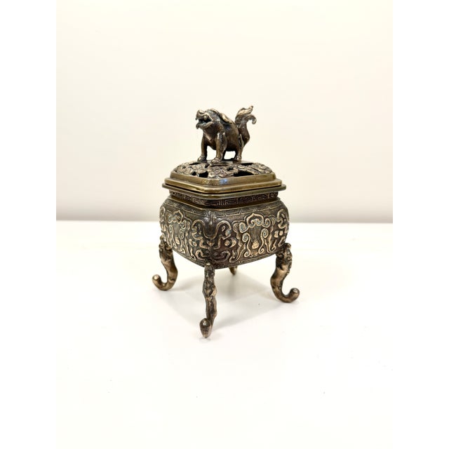 Lovely vintage bronze incense burner features a Foo Dog or mythical creature on a pierced removable lid. This is an ornate...