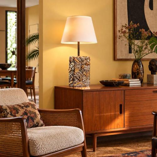 Corrugated ceramic lamp treated with a silver and gold-effect metallic glaze, creating depth and strong geometric...