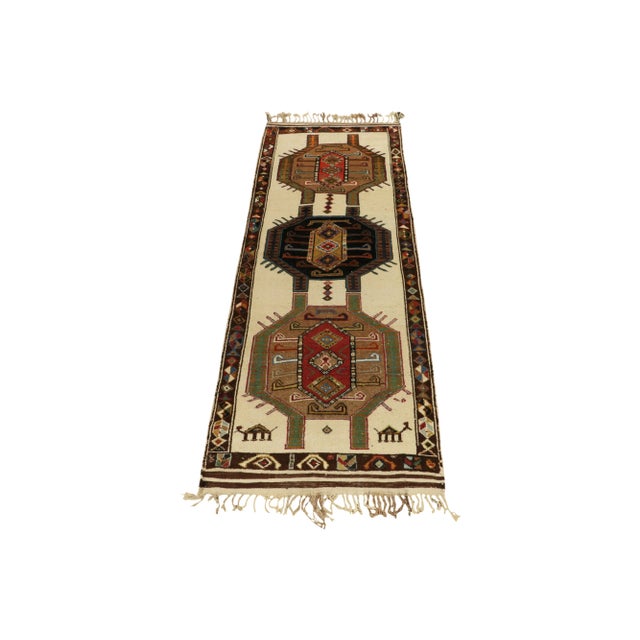 From Rug & Kilim’s vintage selections, a 4x12 hand-knotted wool rug from Turkey bearing graphic, colorful Nomadic...