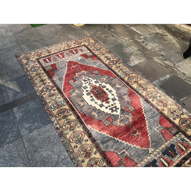 This is a vintage Turkish Oushak rug from the 1960s. The piece was hand-knotted.