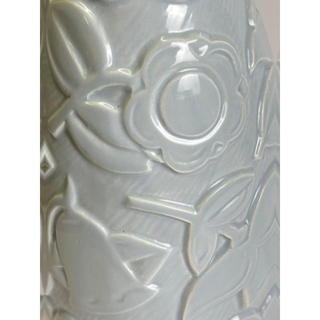 This Art Deco faience vase by St Clement, produced in France circa the 1930s, is finished in a pale blue glaze and...