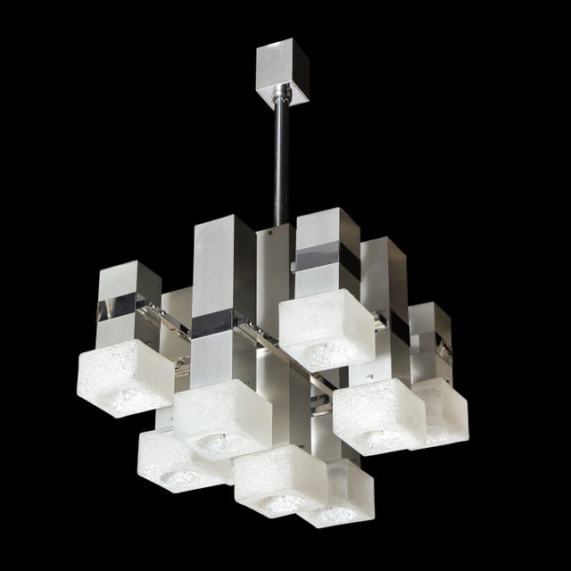 This stunning Mid Century Modern chandelier was realized by the fabled 20th century designer, Gaetano Sciolari in Italy...