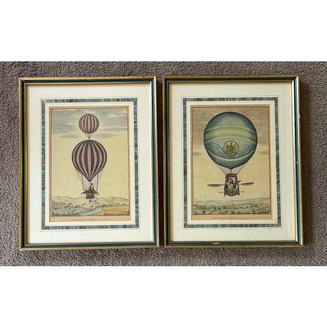 Beautiful pair of antique italian prints of hot air balloons. Behind glass and professionally matted and framed. One is...