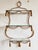Vintage Italian Mid-Century Hollywood Regency style large gilt iron wall mounted shelf with a rope and tassel motif. Each...