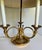 This elegant early 20th century brass bouillotte lamp features a classic French-inspired design with three gracefully...