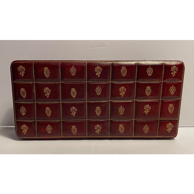 1960s antique maroon leather box, gilt decorated hinged lid with divided three section interior. Holds three sets of...