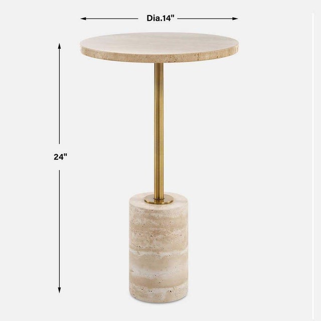 This accent table features a travertine top and base supported by a metal stem in a rich brass finish. The combination of...