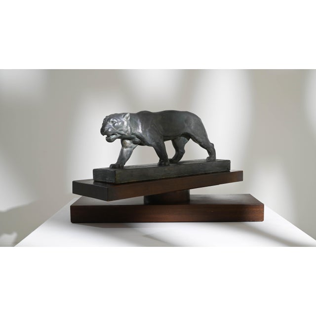 This elegant vintage plaster sculpture depicts a jaguar in motion; head slightly lowered, placing one foot in front of the...