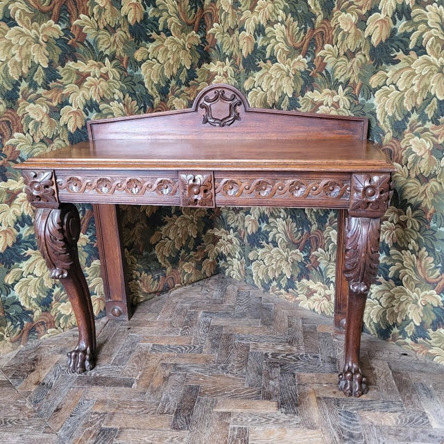 This Victorian oak console table from Hutton-Clarke Antiques showcases the intricate craftsmanship typical of the era. The...
