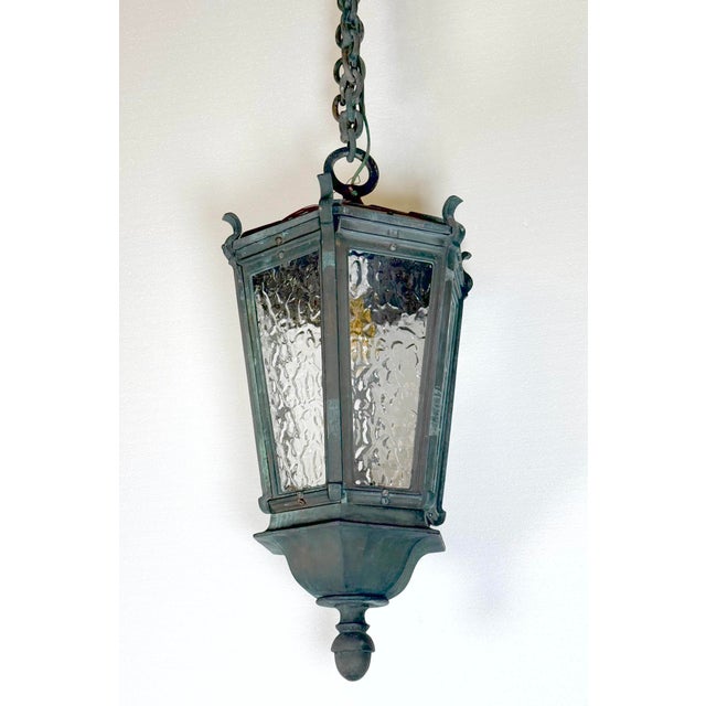 Antique Traditional style ceiling lantern designed for both indoor and outdoor use in entryways or porches. It features a...