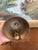 This vintage brass toned hanging bell features intricate hand-painted decoration with traditional Indian motifs. The...