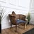 Very decorated armchair in wood and cane with classic blue and gold upholstery. The design and shape of the wooden...