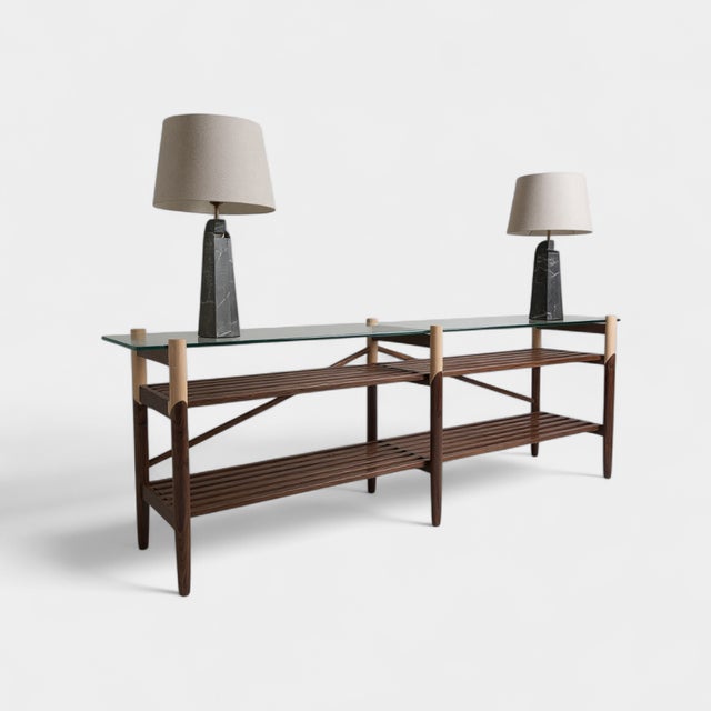 Hand-turned solid wood base. Polished clear tempered glass top. Fine brass accents. We have a custom 8’ console in walnut...