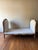 A European walnut daybed from 1880 featuring a finely carved frame and new cream velvet upholstery. Both timeless and...