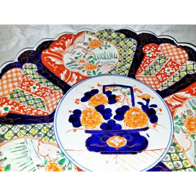 Bold colored classic late 1800-1900s Japanese imari porcelain charger bowl with scalloped edge, hand decorated in...