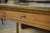 Authentic 1950s work table, generously sized and with a clean, understated look. The tabletop is upholstered with a brass...