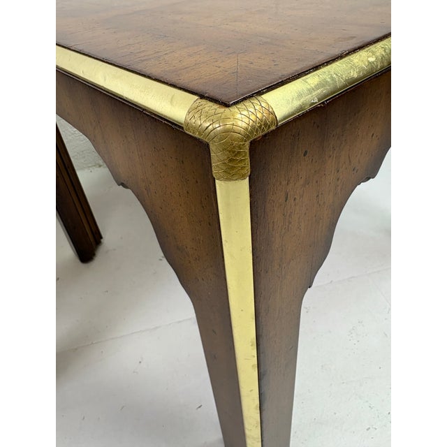 This is a pair of walnut side tables attributed to Baker furniture Co. This pair of side tables have a dark walnut Finish...
