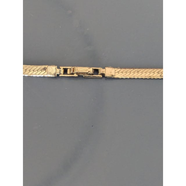 Herringbone gold plated chain, part of the clasp is 14k.