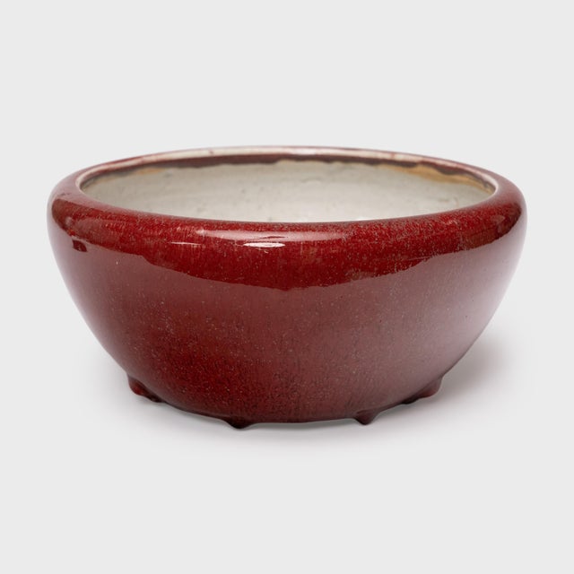 Originally used as a tabletop fish bowl or censer, this antique Chinese basin is drenched in a beautiful flambé glaze with...