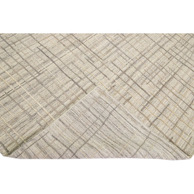 Beautiful Contemporary Thom Filicia Home Collection rugs. This Indian hand-tufted rug is made of wool and has a beige...