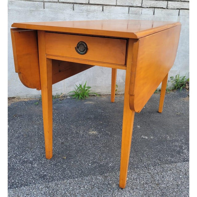 This Charming 1940s American Solid Maple Drop Leaf Breakfast Table is a delightful addition to any vintage-inspired home....