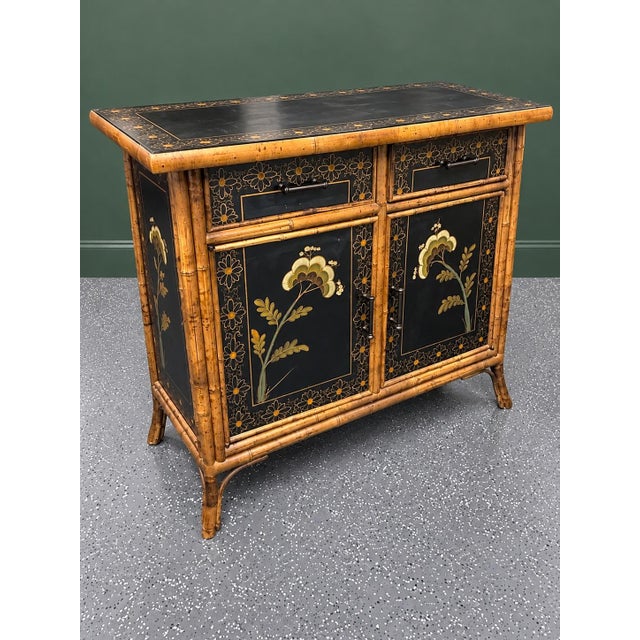 This is a striking vintage bamboo and black lacquer Chinoiserie cabinet in the English Aesthetic Movement tradition. It...