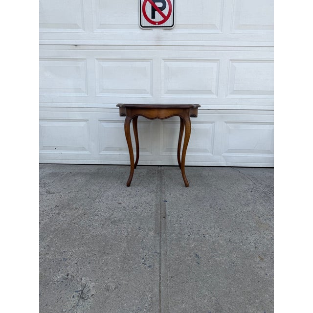 We have a gorgeous vintage French Provincial side table for sale. It features elegant cabriole legs, a scalloped wood top,...