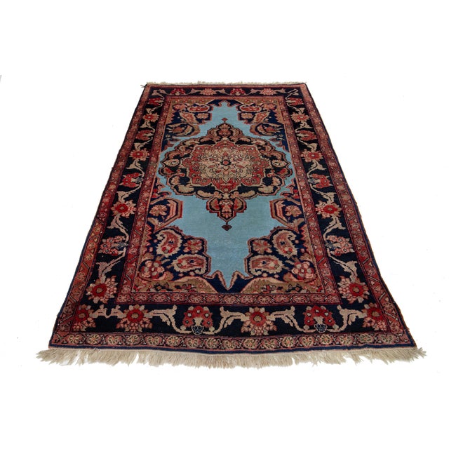 This unique, hand-knotted, Antique Mahal wool rug features a blue field. It is a Persian rug with a red and beige floral...