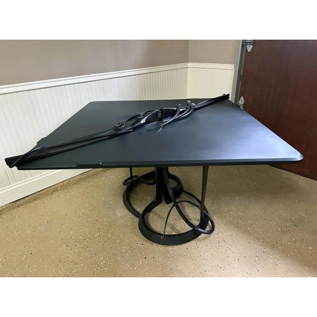 A striking steel and stone table studio-made by American sculptor Albert Paley (1944-). The table heavy and substantial...