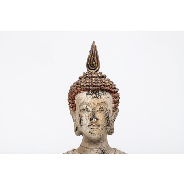 A pair of vintage terracotta standing Buddha figures in flowing robes with a flame finial head-dress, elongated earlobes,...