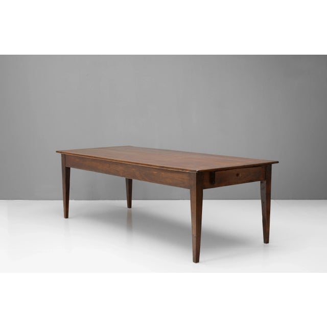 French farm table with polished pine top on cherry base and single drawer at one end. Circa 1880. Apron height - 61cm.