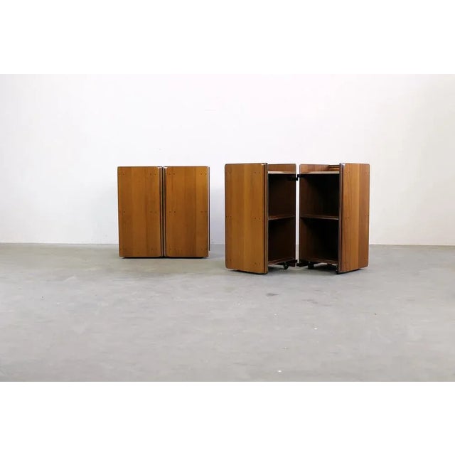 A couple of artona nightstands in walnut wood and metal details. designed by tobia and afra scarpa and produced by maxalto...